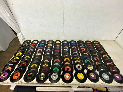 100 Assorted 45 RPM Vinyl Records. Approximately 100 45 RPM vinyl records, featuring various 