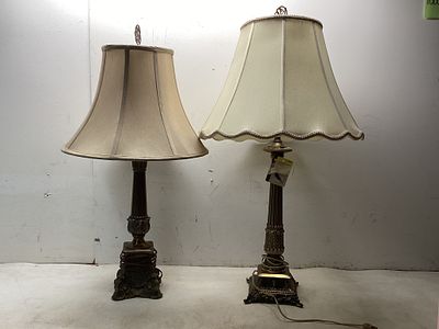2 Brass Table LampsÂ. Two brass table lamps featuring ornate bases and column-style stems with
