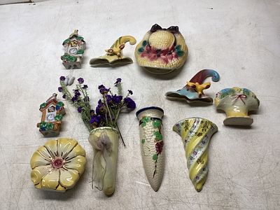 Wall Pocket and Plaques. 11 ceramic wall pockets and decorative plaques, featuring various