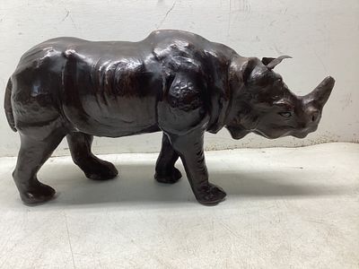 Carved Wooden RhinocerosÂ. Carved wooden rhinoceros sculpture showcasing naturalistic details