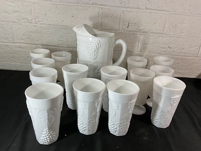 Milk Glass Pitcher with 12 Tumblers. 13 pieces of milk glass, including a footed pitcher and 12