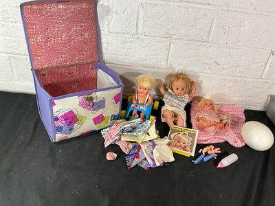 Dolls with Accessories and Storage Box. Dolls and accessories including three small dolls with