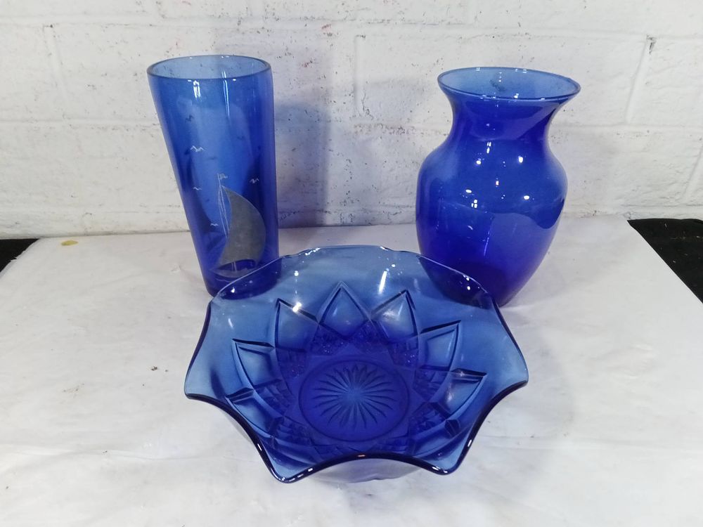 Blue Glass Vases and Bowl. Three blue glass items, including two vases and one bowl. The tall 