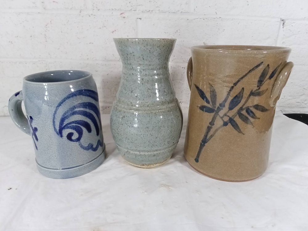 Three Pieces of Handmade Pottery. Three handmade pottery pieces, including a gray-blue mug with 