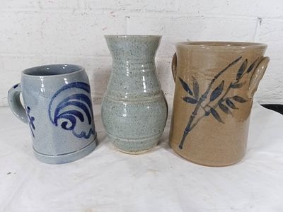 Three Pieces of Handmade Pottery. Three handmade pottery pieces, including a gray-blue mug with 