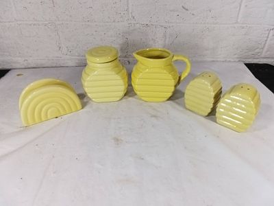 Yellow Ceramic Bee Hive Table Set. Yellow ceramic table set featuring a bee hive design. The set 