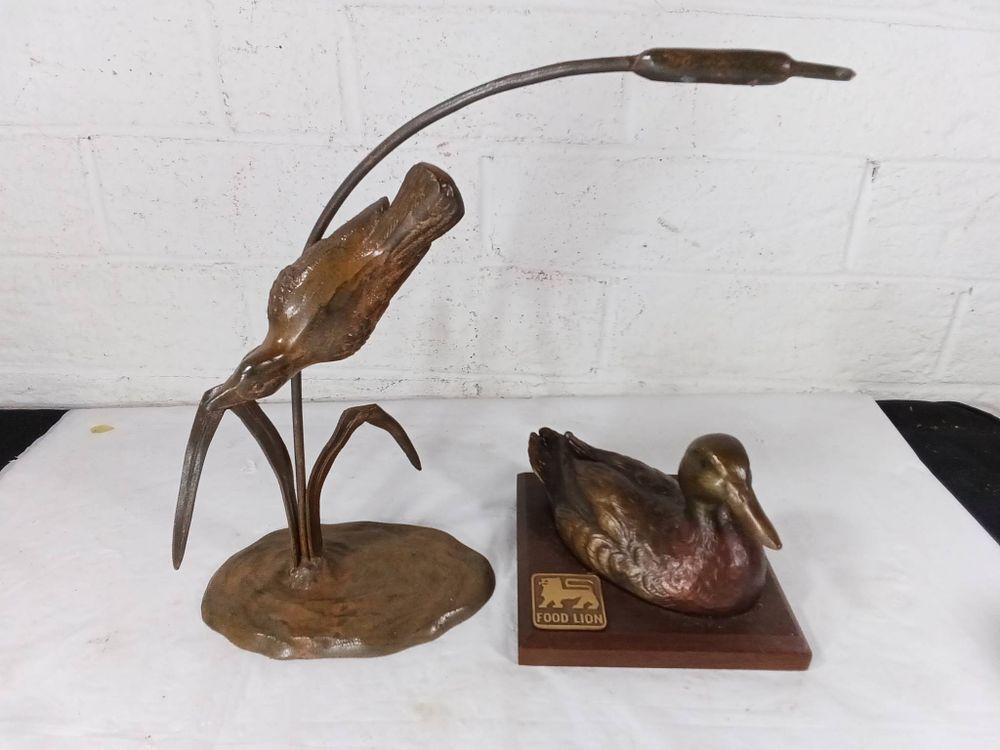 Metal Duck Sculpture and Wood Base Duck Figurine. Two duck-themed decor items. The first is a 