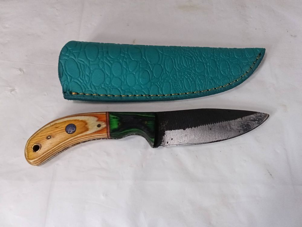 Damascus Blade Knife with Custom Sheath. Damascus steel knife featuring a patterned blade and a 