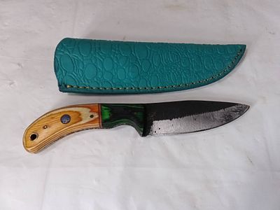 Damascus Blade Knife with Custom Sheath. Damascus steel knife featuring a patterned blade and a 