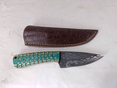 Damascus Knife with Leather Sheath. Fixed-blade knife featuring a Damascus steel blade with a 