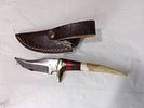Damascus Knife with Bone Handle and Leather Sheath. Damascus knife featuring a distinctive bone Image - 1