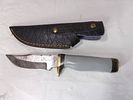 Damascus Steel Knife with Sheath. Damascus steel knife featuring a patterned blade indicative of Image - 1