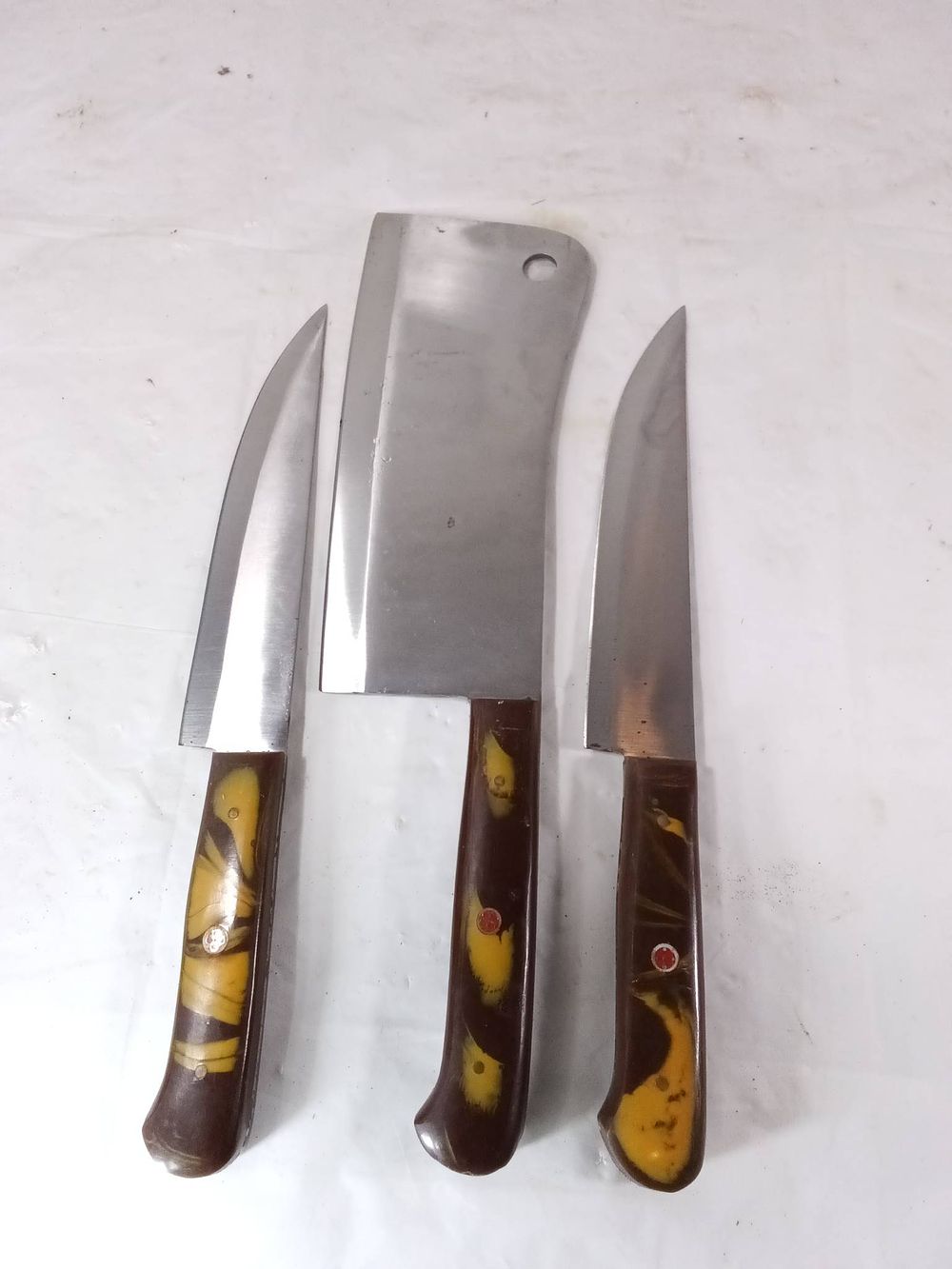 3 Damascus Butcher Knives with Swirled Handles. Three butcher knives crafted with Damascus steel 