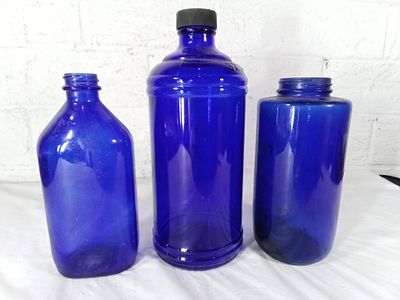 Three Blue Glass Bottles. Three blue glass bottles in varying shapes and sizes. Includes one 