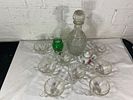 Glass Decanter with Cups and Decorative Items. Glassware set featuring a clear glass decanter Image - 1