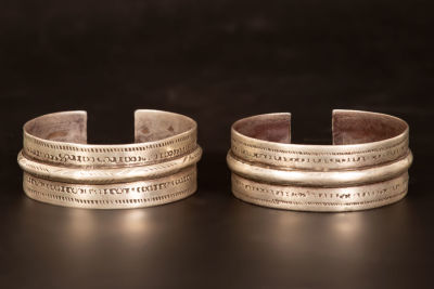 A pair of silver cuff bracelets - Egypt. Each bracelet / armlet is engrved in geometric design. 