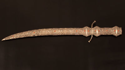 An Islamic Shamshir silver and coral sword. Sword and sheath are made of silver decorated with 