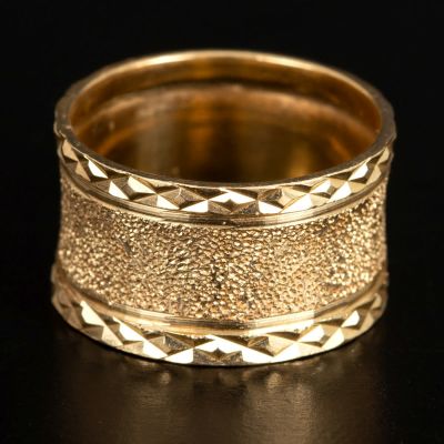 An engagement ring made of 14K yellow gold. A substantial wedding ring made of 14K yellow gold 