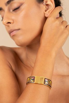 A click-clack bracelet by Hermes, made of gold-plated metal. Herm&egrave;s gilt metal and enamel 