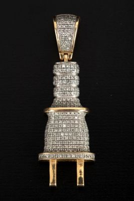 Small 10 karat gold pendant, adorned with small diamonds. 10 karat gold pendant in a plug-like 