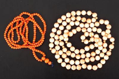 Two coral necklaces, one with 18K gold pearls. One necklace consists of small and non-uniform 