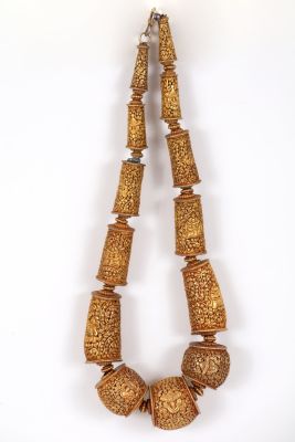 Gold plated link chain, China/Tibet. The links gradually grow into a large round central 