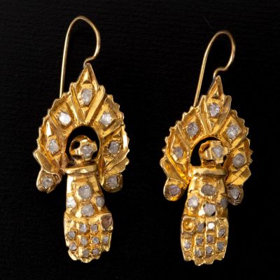 Vintage gold earrings set with diamonds. Old gold earrings made of low-grade gold, set with 