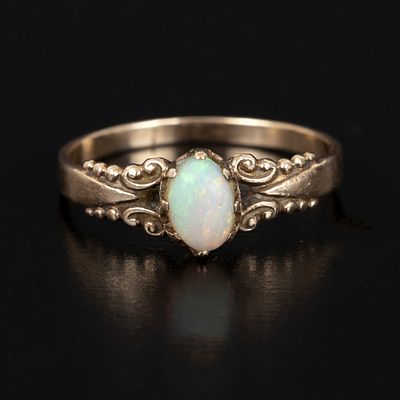 Vintage 9K Yellow Gold and Opal ring. crafted in a solitaire style, containing one oval shape 