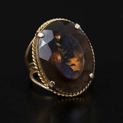 14K Yellow Gold and Smoky Quartz Ring. containing one oval shape modified brilliant cut smoky 