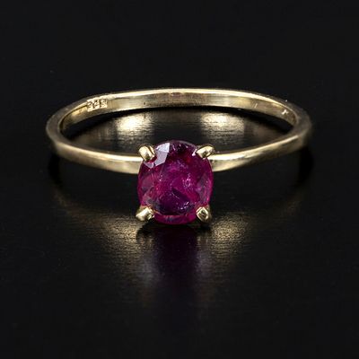 14K Yellow Gold and Ruby Solitaire Ring. containing one oval shape mixed cut ruby weighing 