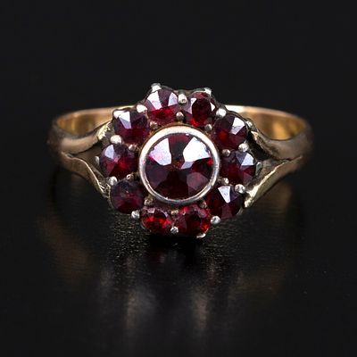 Antique 14K Gold and Garnet Ring. silver topped yellow gold ring containing 11 round mixed cut 