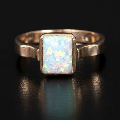 14K Yellow Gold and White Opal Ring. solitaire design containing one rectangular cabochon cut 