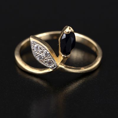 14K Gold, Sapphire and Diamond Ring. a lovely ring containing one marquise shape mixed cut 