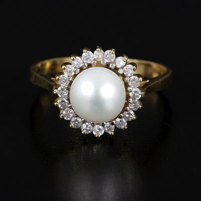 18K Yellow Gold, Pearl and Diamond Halo Ring. a lovely halo ring containing one round white 