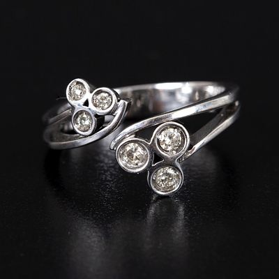 14K White Gold and Diamond Ring. containing six round brilliant cut diamonds weighing 