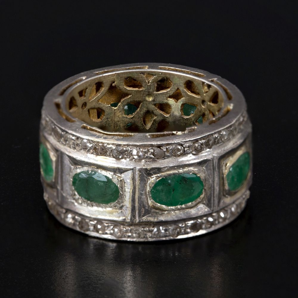Gold, Silver, Emerald and Diamond Ring. containing eight oval shape mixed cut emeralds weighing 