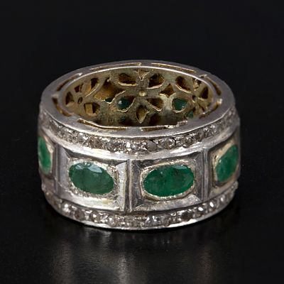 Gold, Silver, Emerald and Diamond Ring. containing eight oval shape mixed cut emeralds weighing 