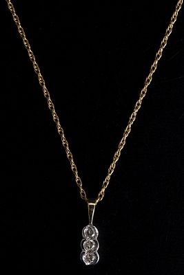 14K Gold and Diamond Necklace. a sweet slide pendant containing three round brilliant cut 