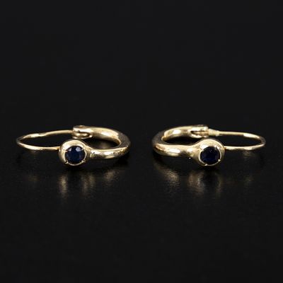 14K Yellow Gold and Sapphire Hoop Earrings. containing two round mixed cut sapphires weighing 