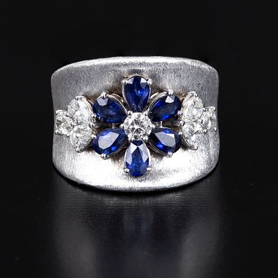 18K White Gold, Sapphire and Diamond Ring. crafted in a floral design with fine brush finish 