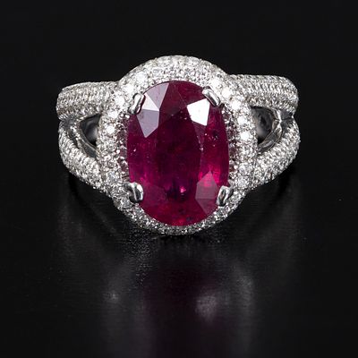 Belgian Designer 18K Gold, Ruby and Diamond Ring. an impressive custom made 18K white gold halo 