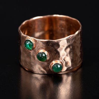 Artistic 14K Yellow Gold and Emerald Ring. hammer finish along the body of the ring, containing 