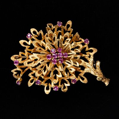18K Yellow Gold and Ruby Brooch. designed in a stylized natural scence, measuring approximately 