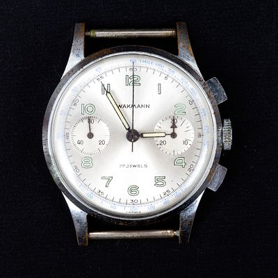 mid-century wakamann watch . Metal body with silver bezel and light green numerals. Manual 