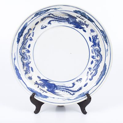 A large oldChinese bowl. A large and massive bowl decorated with a scene with a phoenix and a 