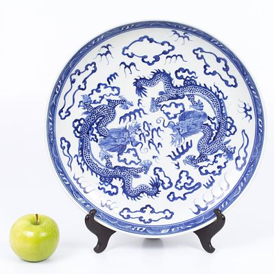 Large hand painted Chinese bowl. The inside of the plate depicts a scene with dragons. Signed on 