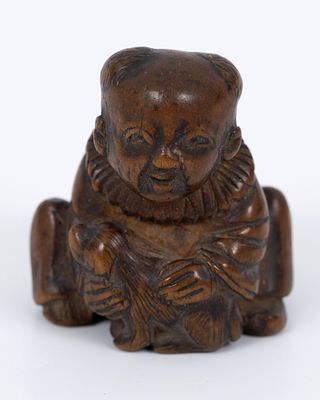 Old Netsuki carved in wood, Japan. Netsuki is carved in the image of Karako, dressed in 