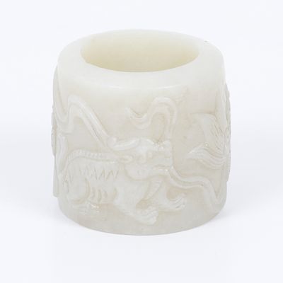 Old archer ring carved in white jade, China. The ring is carved with foo dog motifs Weight of 