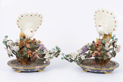 A pair of Chinese bird sculptures carved in jade and gemstones on cloisonn&eacute; vase bases. A pair 