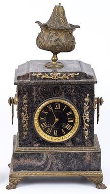 An old European clock made of marble and bronze. A decorative marble clock, combined with 